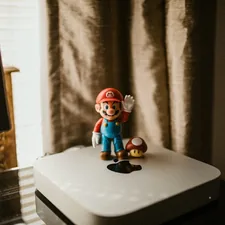 a nintendo figurine sitting on top of a white box related to Transform Your Bedroom with a Nintendo Bed Set: A Gamer's Dream