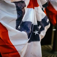 A patriotic bunting adorns a pole. related to The Divisive Symbol of Comfort: A Controversial Look at Confederate Flag Bedding