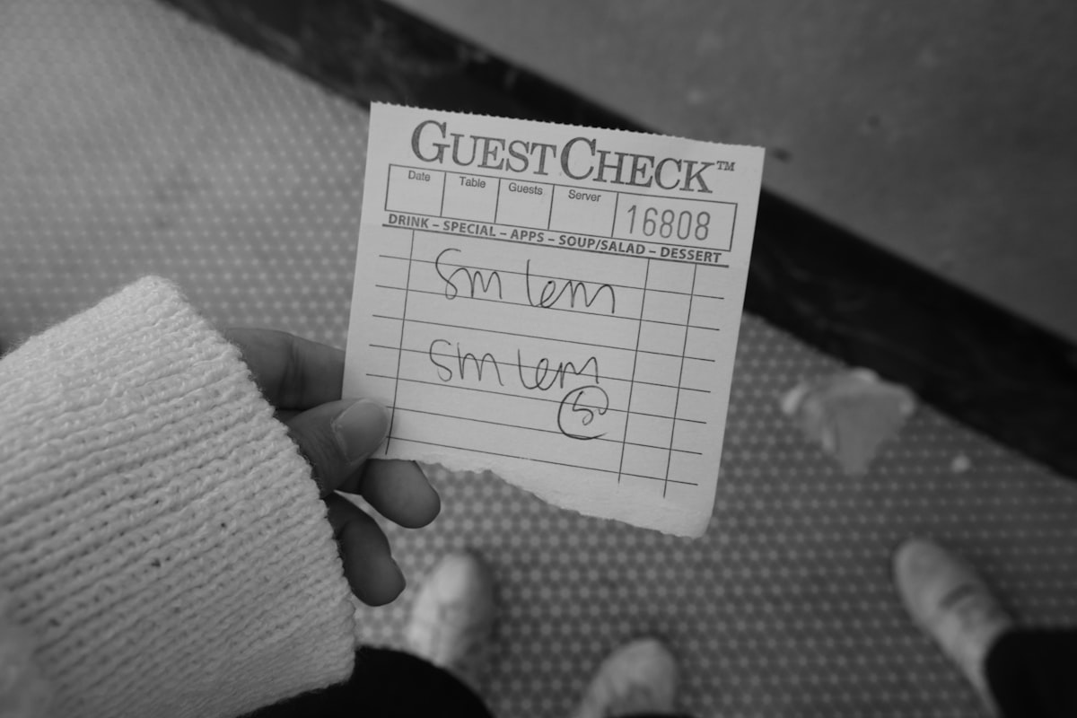 A person holding a check card in their hand related to Ultimate Guide to Detecting Bed Bugs