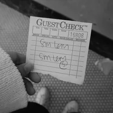 A person holding a check card in their hand related to Ultimate Guide to Detecting Bed Bugs