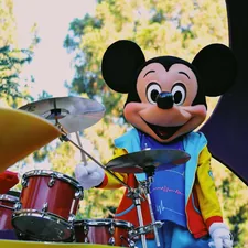 a person in a garment playing drums related to Mickey Mouse Valence Curtains