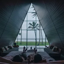 a person laying on a bed in front of a window related to Elevate Your Space with Stunning Valance Window Treatments