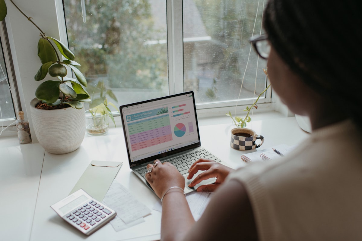 a person working on the laptop related to Elevate Your Windows on a Budget: Cheap Curtain Valances to Transform Your Space