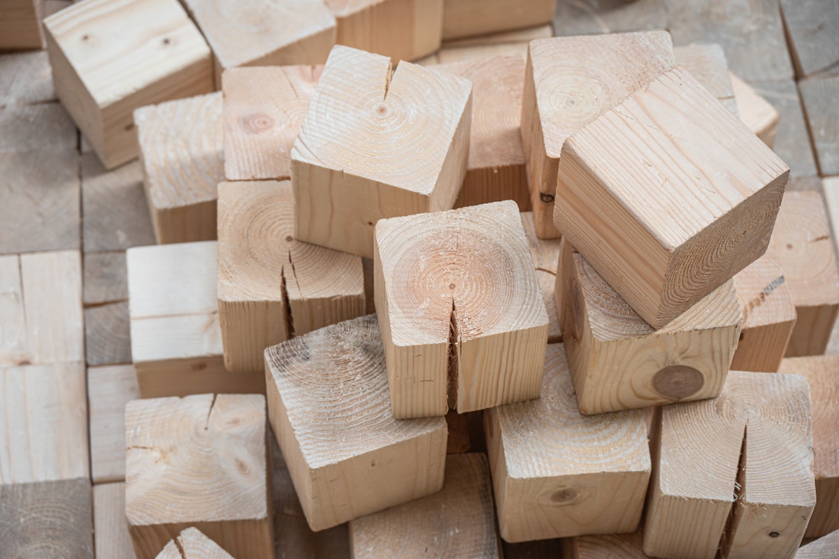 A pile of natural wooden building blocks. related to Elevate Your Sleep: Discover the Benefits of Wooden Bed Risers