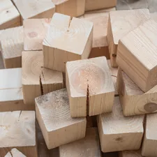 A pile of natural wooden building blocks. related to Elevate Your Sleep: Discover the Benefits of Wooden Bed Risers