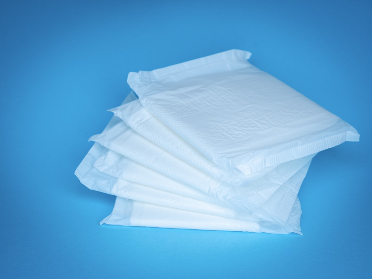 a pile of white tissue sitting on top of a blue table related to The Ultimate Guide to Disposable Bed Pads