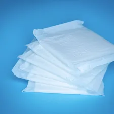 a pile of white tissue sitting on top of a blue table related to The Ultimate Guide to Disposable Bed Pads