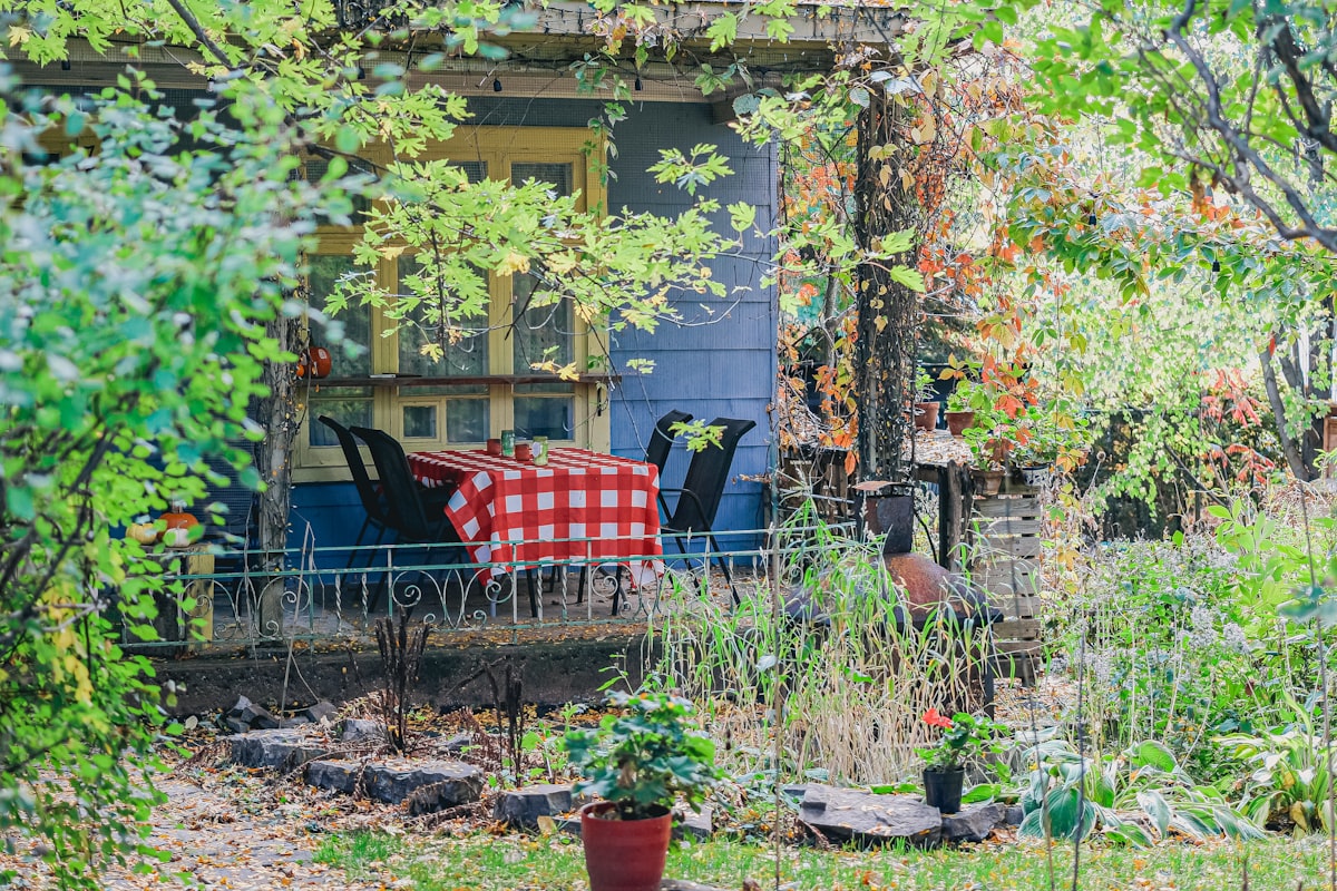 A porch with a checkered tablecloth and chairs related to Transform Your Garden with Home Depot's Raised Beds: The Ultimate Guide