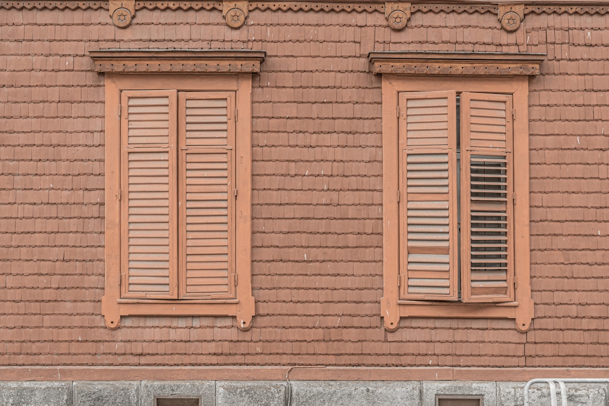 a red brick building with two windows and a bench related to Wooden Valances for Windows | Best Designs and Ideas