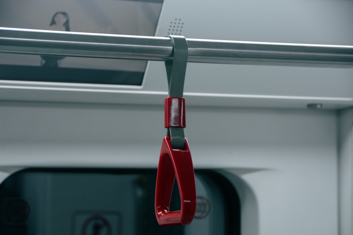 a red pair of scissors hanging from a rail related to The Ultimate Guide to Choosing the Best Bed Assist Handle