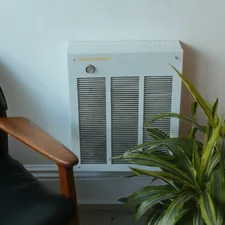 A room with a chair and a heater related to Affordable Comfort: The Best Low-Cost Beds for Every Home