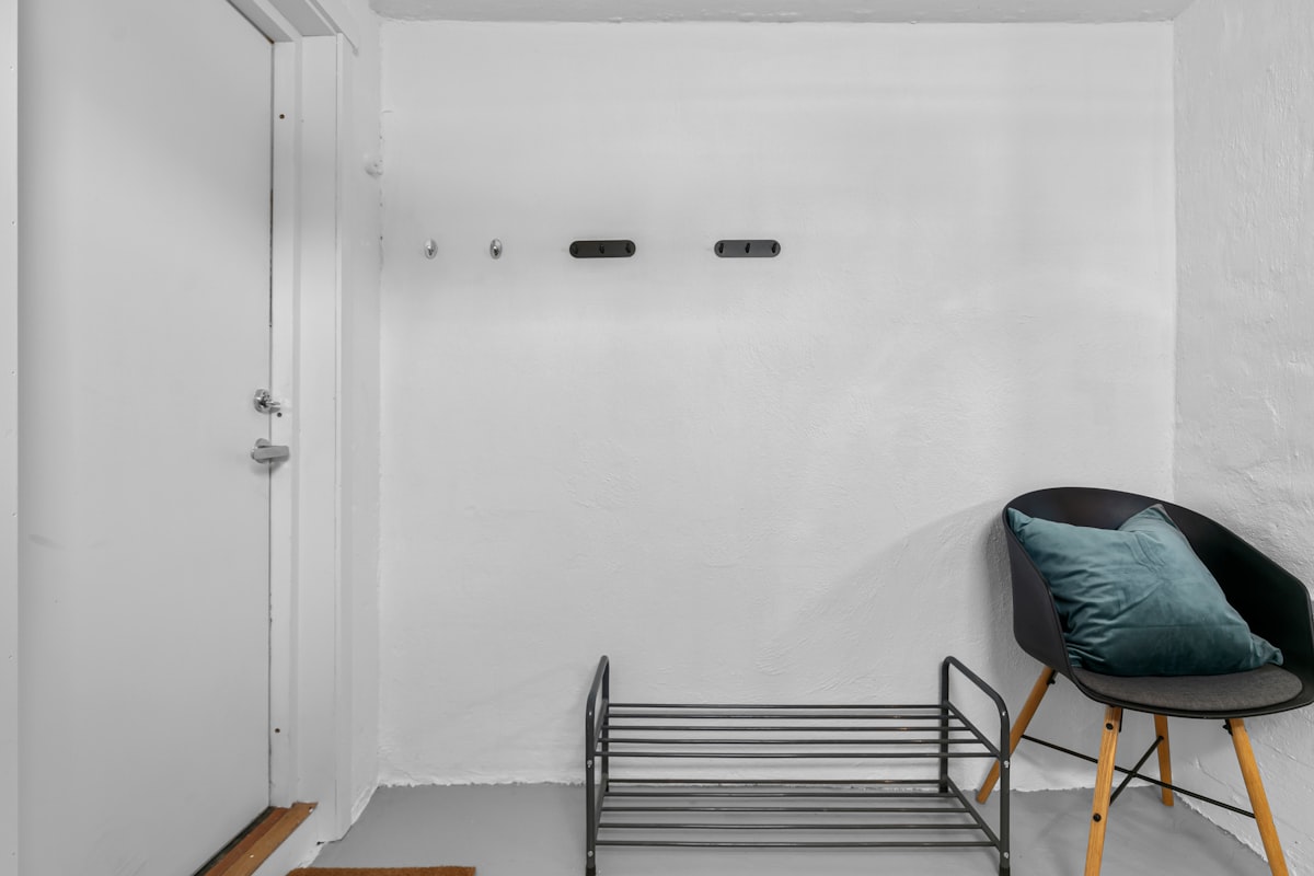 A room with a chair and a shelf in it related to Maximize Entryway Style with a Bench and Shelf Set