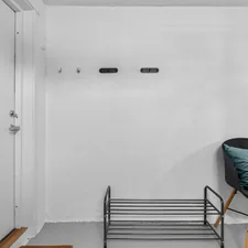 A room with a chair and a shelf in it related to Maximize Entryway Style with a Bench and Shelf Set