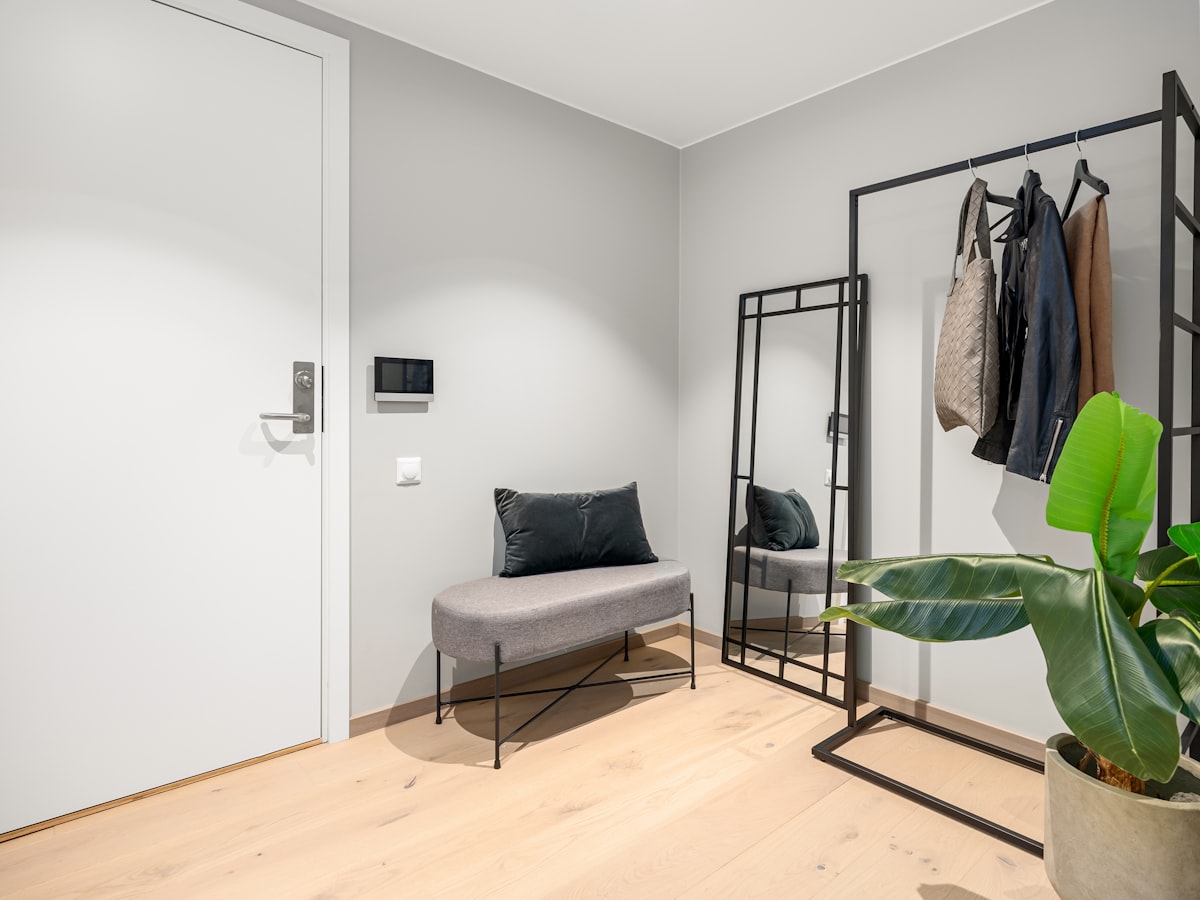 A room with a couch and a coat rack related to Transform Your Entryway with a Metal Storage Bench and Coat Rack