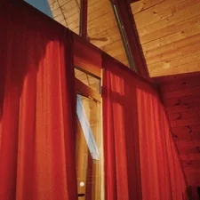 a room with a red curtain and a ceiling fan related to Target Valances Curtains: Elevating Your Home Decor