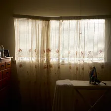 a room with a table and a window with sheer curtains related to Transform Your Bedroom with Texas Flag Bedding