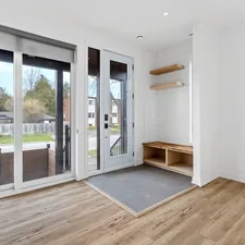 a room with a wood floor and a glass door with a rug and a wood floor with a related to Elevate Your Entryway: The Ultimate Guide to Benches with Storage and Hooks