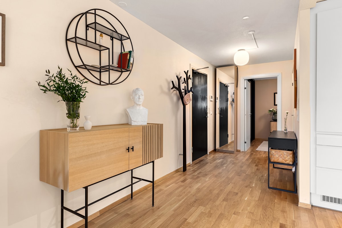 A room with a wooden floor and white walls related to Maximizing Space and Style: Entryway Hall Trees with Storage