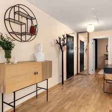 A room with a wooden floor and white walls related to Maximizing Space and Style: Entryway Hall Trees with Storage