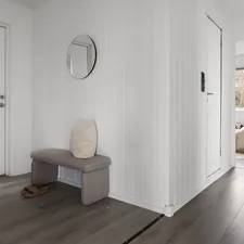 A room with white walls and wood floors related to Cozying Up the Entrance: The Ultimate Guide to Narrow Entryway Benches