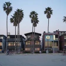 a row of palm trees next to a beach related to Maximizing Space with Murphy Beds in Los Angeles