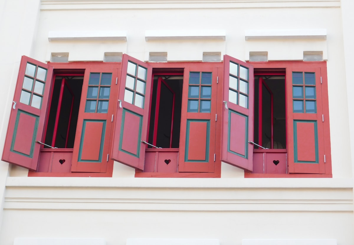 a row of red shutters on the side of a building related to Red Window Valances: Elevate Your Home Decor