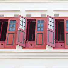 a row of red shutters on the side of a building related to Red Window Valances: Elevate Your Home Decor