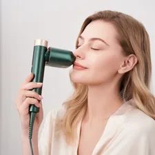 A serene moment is captured as a model gently uses a laser hair removal device on her face, showcasing the product's versatility and gentle application. related to Revitalize Your Skincare Routine with Face Steamers from Bed Bath & Beyond
