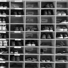 A shelf filled with lots of pairs of shoes related to Stylish Shoe Storage Solutions: Shoe Trays for Your Entryway