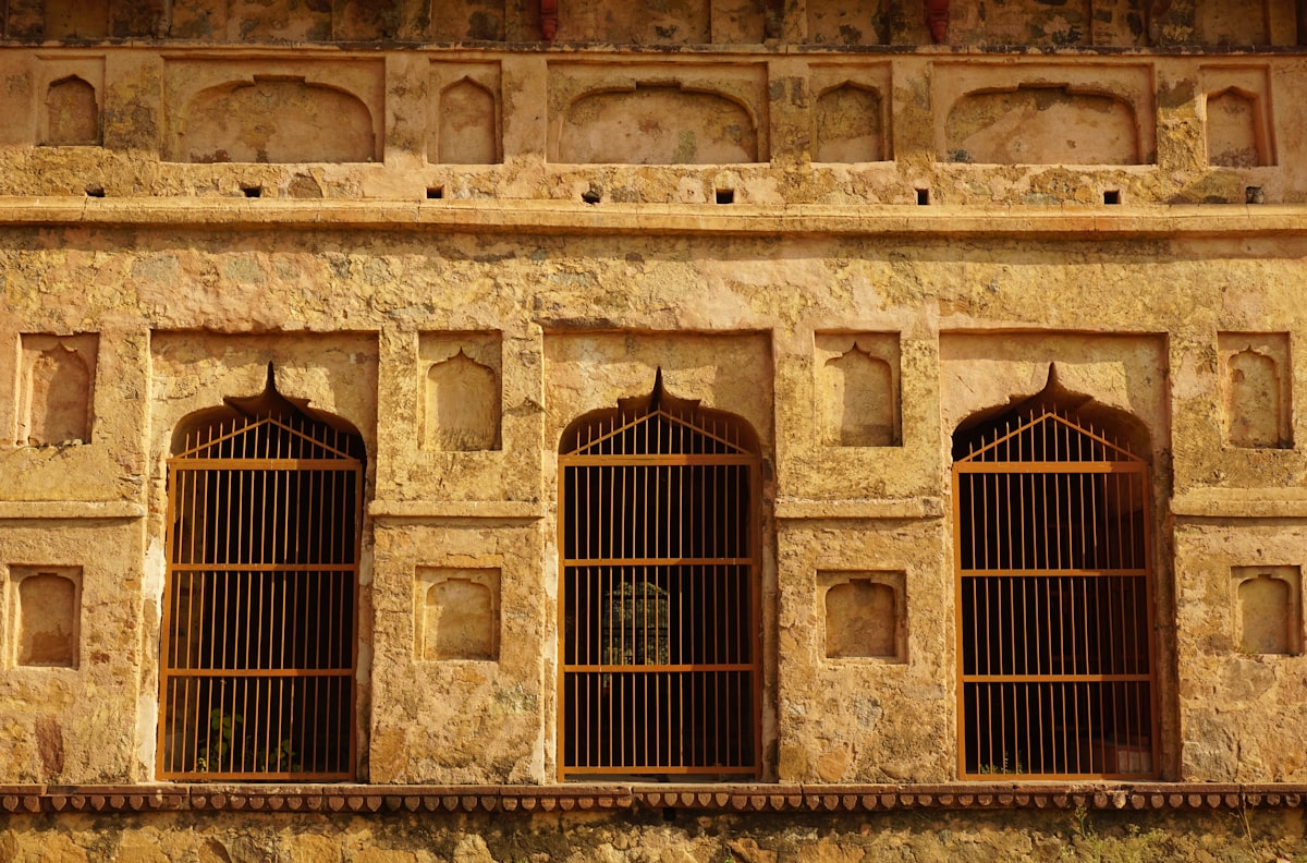 a stone building with four windows and bars related to Traditional Window Valances