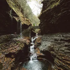 a stream with a bridge over it related to Discover the Charm of Watkins Glen: A Bed and Breakfast Getaway