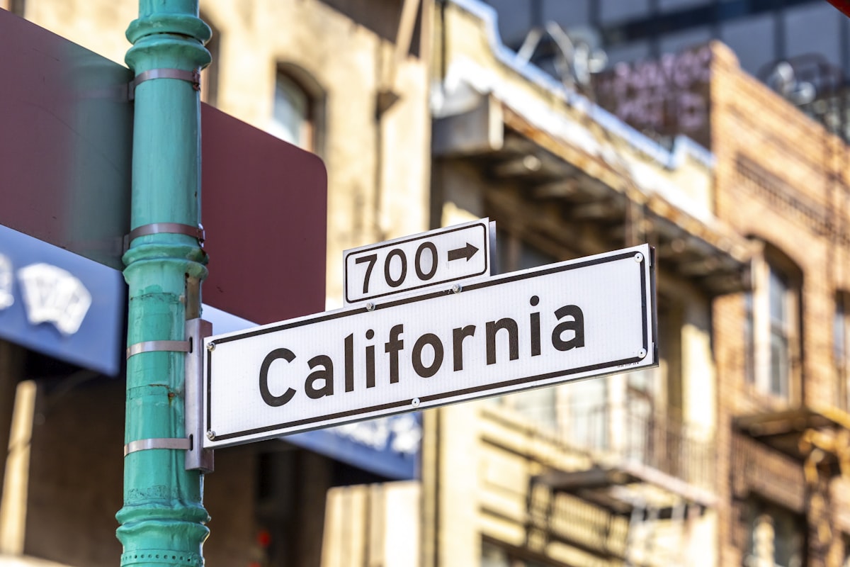 A street sign for california street with building background. related to Exploring the Dimensions of a California King Size Bed