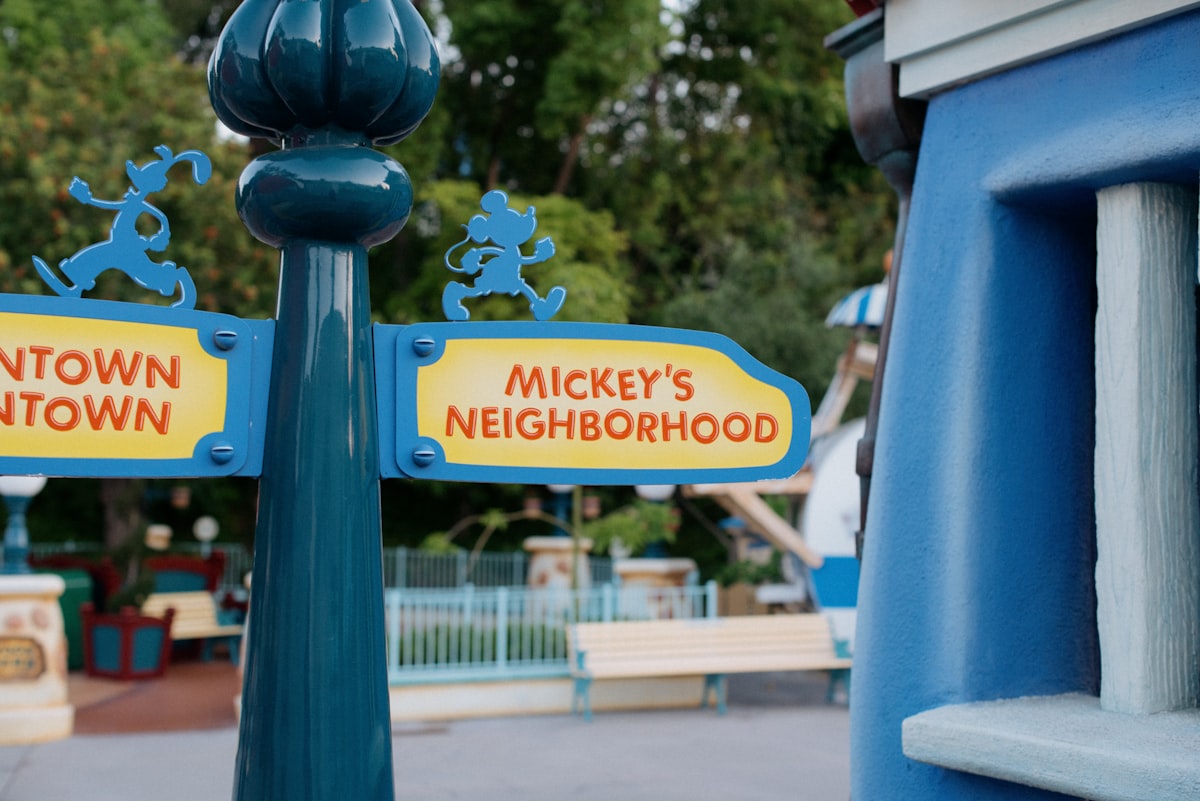 a street sign in front of a playground related to Cozy Up with Mickey: The Ultimate Bedroom Experience