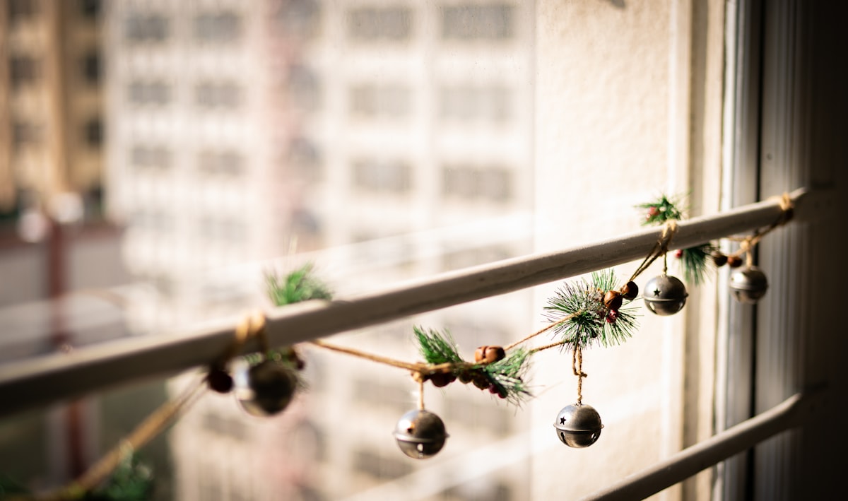 a string of bells hanging from a window related to Elevating Your Window Decor: A DIY Guide to Creating Stunning Valances