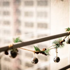 a string of bells hanging from a window related to Elevating Your Window Decor: A DIY Guide to Creating Stunning Valances