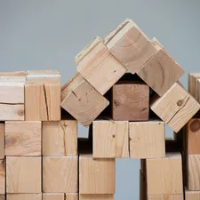 A structure made of wooden blocks resembling a house. related to How to Build a Raised Flower Bed: A Step-by-Step Guide