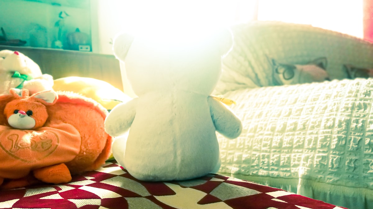 a stuffed animal sitting on top of a bed related to Toys R Us Child Bed: A Dream Come True for Kids