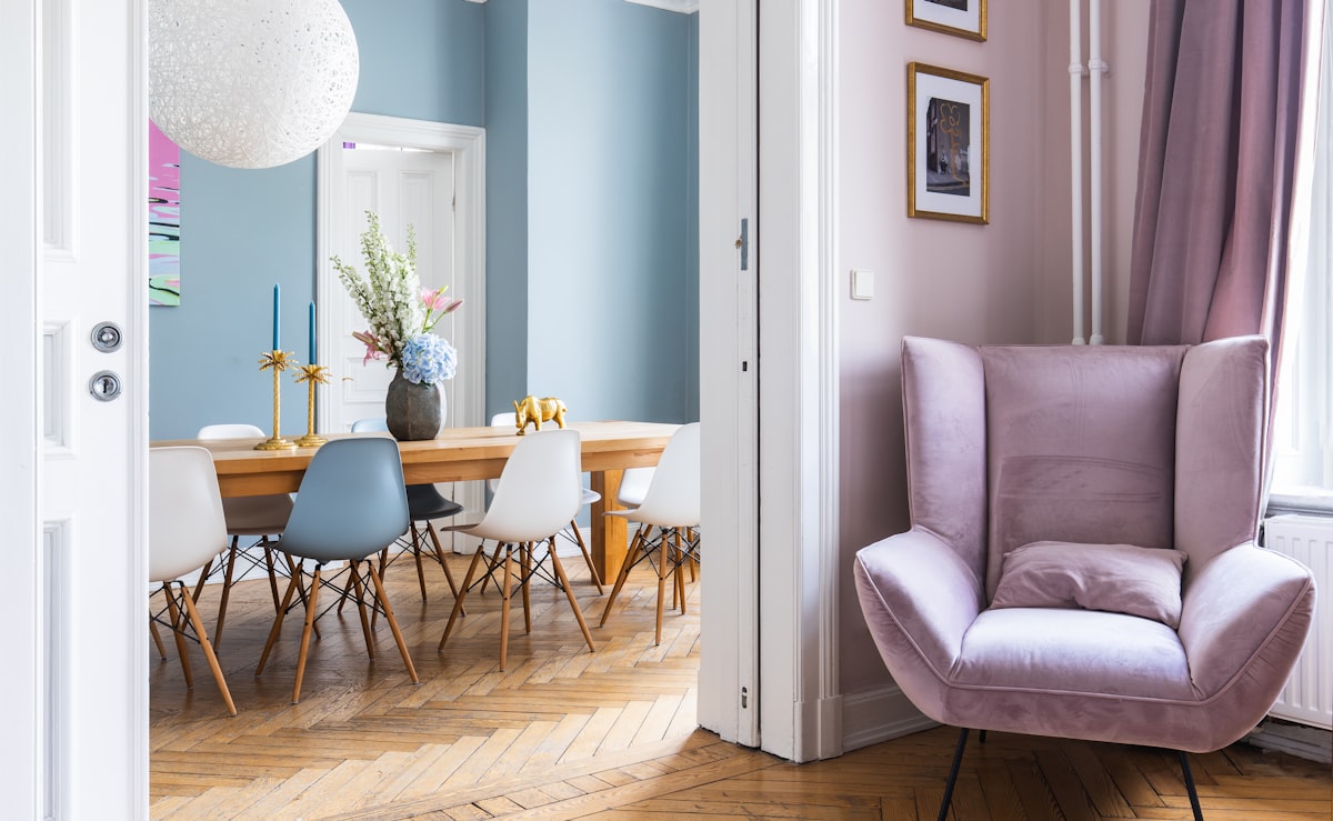 A stylish dining room with a solid wood table in an old building. related to Elevate Your Home with Chic Bay Window Valance Ideas