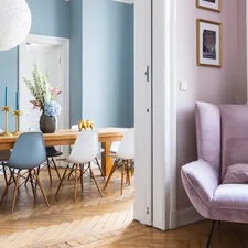 A stylish dining room with a solid wood table in an old building. related to Elevate Your Home with Chic Bay Window Valance Ideas