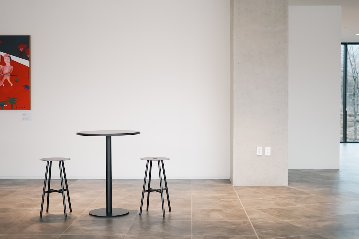 a table and two stools in a room related to Round Entryway Tables: Embrace Elegance and Functionality
