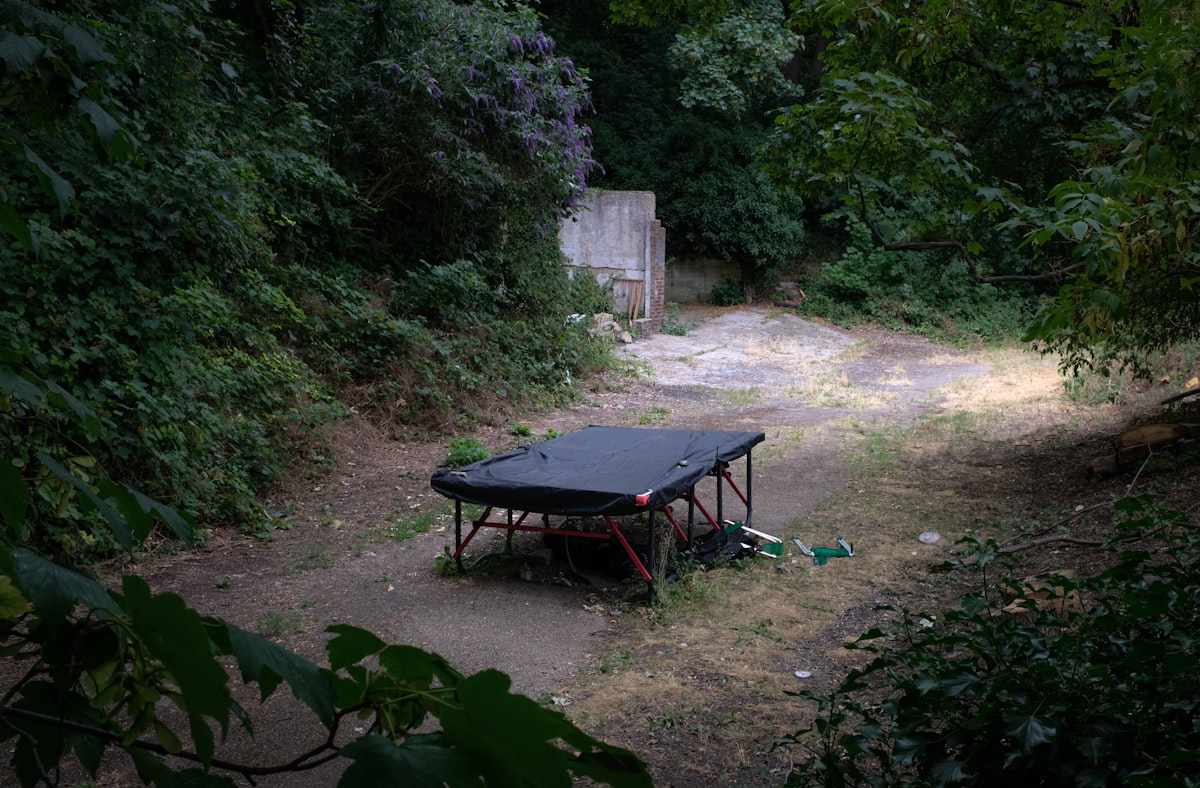 a table outside in the middle of a garden related to Elevate Your Camping Experience with Double Camping Beds
