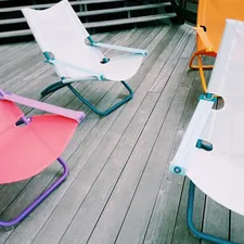 a table with a chair and a table with a chair and a table with a white tablecloth related to The Ultimate Sleeping Solution: Kids' Fold Out Chair Beds