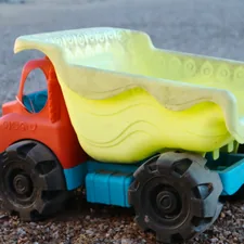 a toy dump truck with a plastic dumpster in the back related to Transform Your Toddler's Room with a Dump Truck Toddler Bed