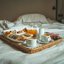 a tray of breakfast on a bed with white sheets related to Exploring the Charm of Bed and Breakfasts