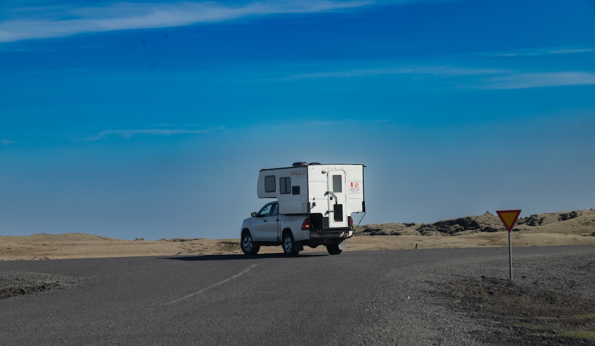 a truck driving down a road with a camper on the back related to Exploring Spacious RV Options for Families