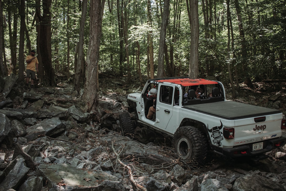 a truck driving through a forest related to Protect Your Ride: The Ultimate Guide to Bed Covers For Trucks