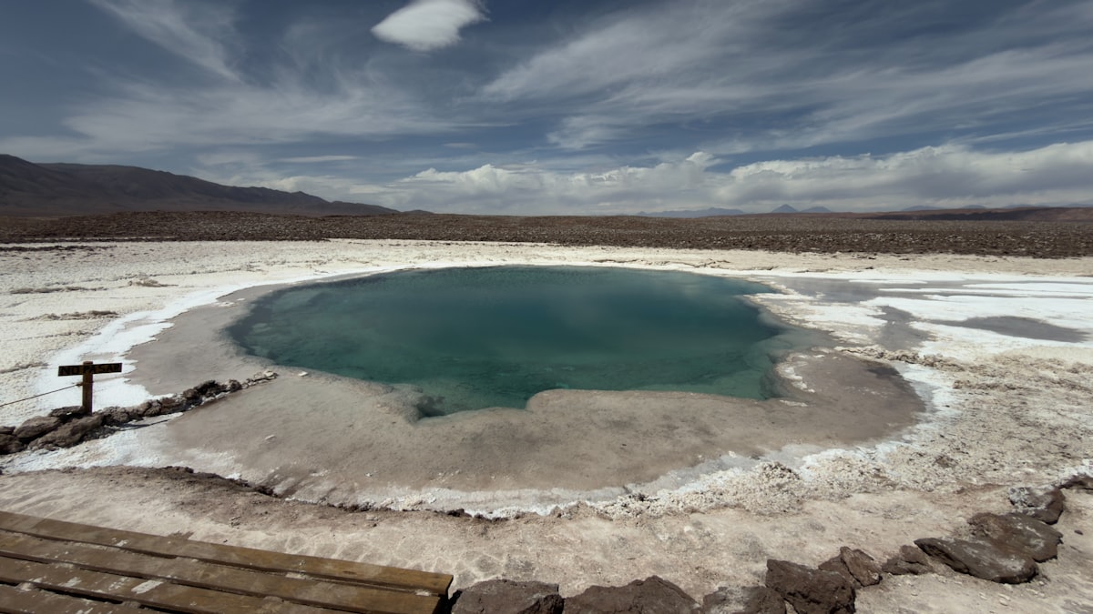 A turquoise hot spring surrounded by white salt flats. related to The Ultimate Guide to Bed and Breakfasts in Hot Springs, Arkansas