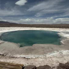 A turquoise hot spring surrounded by white salt flats. related to The Ultimate Guide to Bed and Breakfasts in Hot Springs, Arkansas