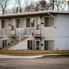 a two story white building with stairs leading up to it related to Find Your Perfect 2-Bed Apartment for Rent: Affordable Living Solutions
