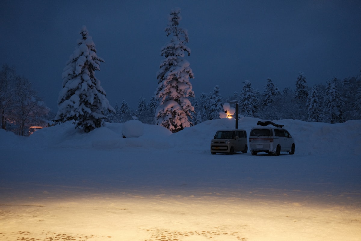 A van parked in the snow at night related to Camping Beds for a Cozy Night Under the Stars: Walmart Options